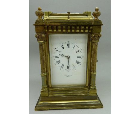 A brass four-glass sided carriage clock, with four Corinthian columns, retailed by John Dyson, Leeds. French movement, gong s