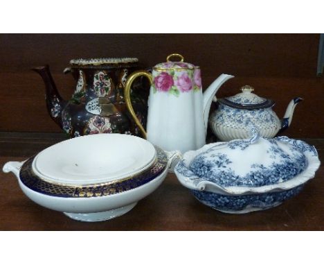 A bargeware teapot, lacking lid, a Victorian blue and white teapot and teapot stand, a Bavarian coffee pot and two tureens, a