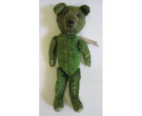 A pre-war green jointed teddy, with shoe button eyes, sewn nose and felt pads, 13 1/4" long (Est. plus 21% premium inc. VAT)