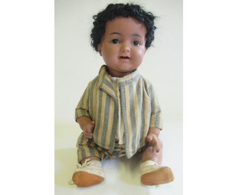 A Kammer &amp; Reinhardt bisque socket head character boy doll, with brown glass sleeping eyes, open mouth, teeth, sprung ton