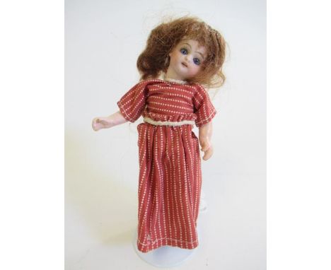 A possible Kammer &amp; Reinhardt bisque socket head dolls house doll, with blue glass sleeping eyes, open mouth, five piece 