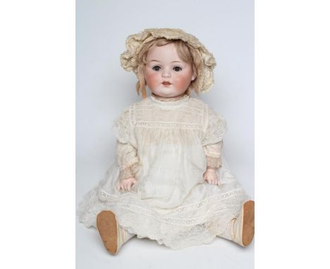 A Heubach bisque socket head doll, with blue glass sleeping eyes, open mouth, teeth, blond wig, wood and composition jointed 