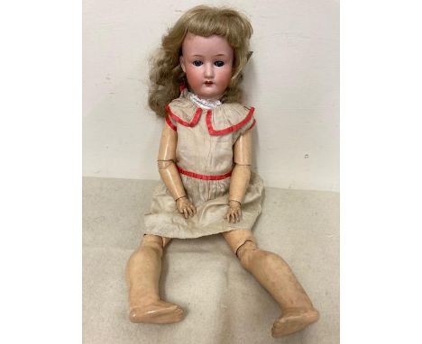 A Heubach Koppelsdorf bisque socket head doll, with blue glass sleeping eyes, open mouth, teeth, blond wig, wood and composit