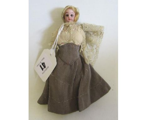 A bisque shoulder head dolls house doll, with brown glass fixed eyes, blond wig, bisque arms, cloth body, and lace veil, 5 3/