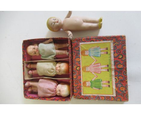 A boxed set of three Paradise dolls, all three bisque with jointed shoulders and moulded features, 3 3/4" high, together with