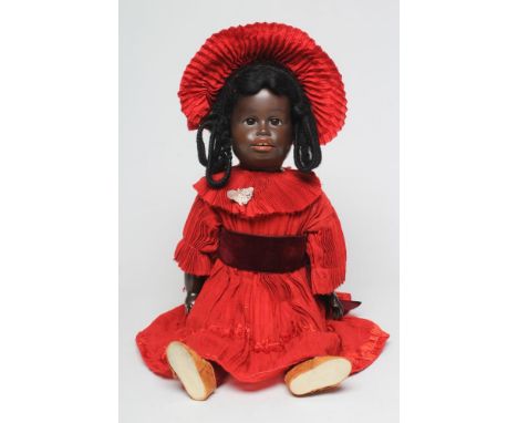 A rare Gebruder Kuhnlenz bisque socket head doll, with brown glass sleeping eyes, open mouth, teeth, black wig, wood and comp