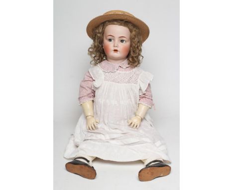 A Kammer &amp; Reinhardt bisque socket head flirty eye doll, with blue glass flirty eyes, sleeping eyelids, open mouth, teeth