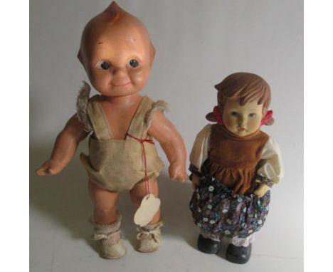 A Kewpie cameo doll, design by Rose O'Neill, with jointed neck, shoulders and hips, label and original clothes, 12 1/2" long,