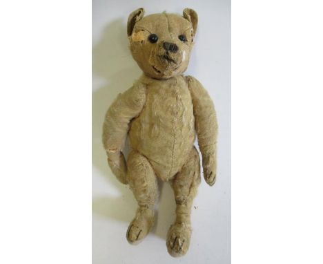 An early Steiff centre-seam teddy, with shoe button eyes, sewn nose and orange plush, 15 1/2" long (Est. plus 21% premium inc