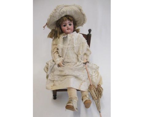 A Simon &amp; Halbig bisque socket head doll, with brown glass sleeping eyes, open mouth, teeth, pierced ears, blond wig, com