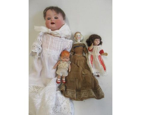 Four small dolls, comprising a 9" Heubach Koppelsdorf bisque socket head doll, with blue glass sleeping eyes, open mouth, tee