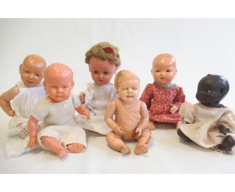 Six dolls, five of which vintage celluloid examples with jointed bodies, and one composition mulatto baby doll (Est. plus 21%