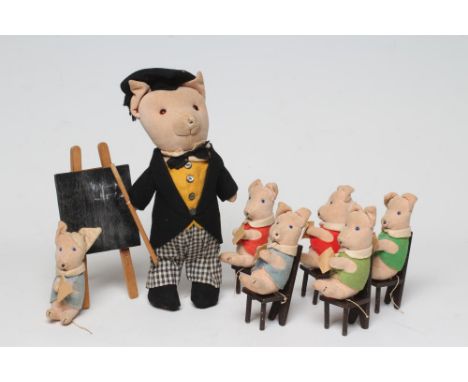 A pre-war Chad Valley pig school, 11 5/8" tall teacher, with tails jacket, hat, cane and label to foot, together with six pup
