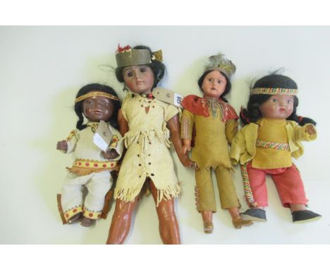 Two Native American themed bisque socket head dolls, comprising a 16 1/4" girl doll, with brown glass fixed eyes, closed mout