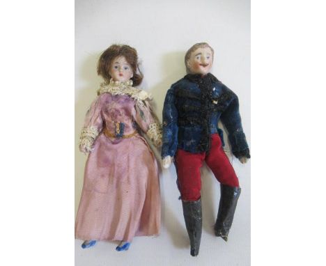 Two bisque shoulder head dolls house dolls, comprising a 5 1/4" man doll with moulded hair, moulded moustache and painted fea