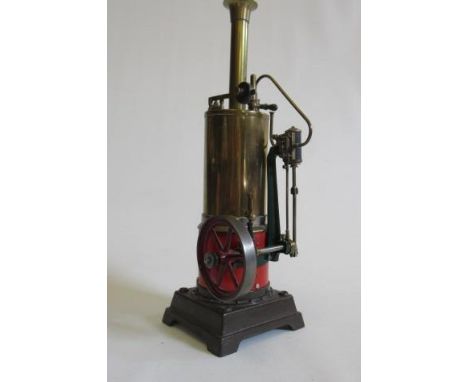 A single cylinder vertical toy steam engine fitted with water gauge, whistle and safety valve, unknown manufacture, on cast b