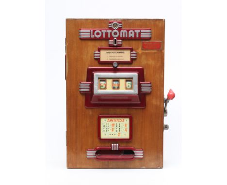 A Lottomat "one armed bandit" slot machine of wooden construction, mounted with decorative metal fittings, 18 1/4" x 28", bac