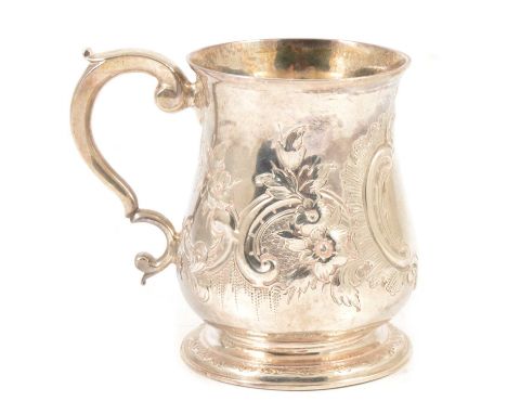 A silver tankard, possibly John Fossey, London 1742, repousse chased floral and scroll design, vacant cartouche, gilt interio