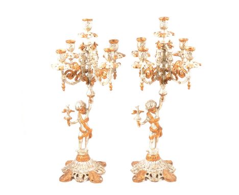 Two modern cast metal five-light candelabra, cherub stem, gilt and silvered finish, 45cm.Qty: 2Condition report:There is some