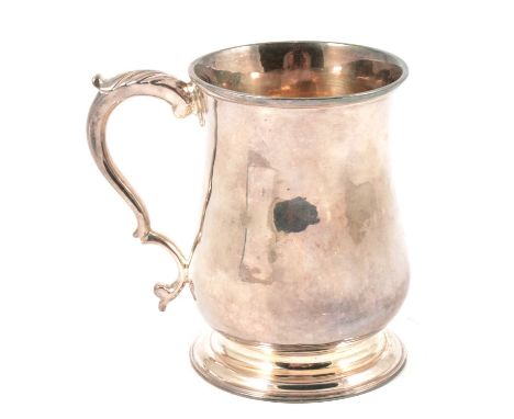 A George III silver tankard, maker's mark indistinct, London 1771, plain polished finish, double scroll handle with leaf thum