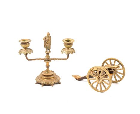 Brass candlestick; and a modern table cannon, (2).