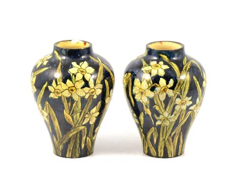 Pair of Doulton Faience vases painted by M Adams, dated 1876, painted with narcissus flowers against a navy blue ground, 16cm