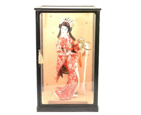 Japanese traditional doll, in ebonised glazed collectors cabinet, 54cm high, depth 25.5cm. 