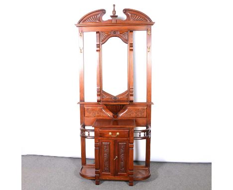 Reproduction mahogany hall stand in the Victorian style, architectural pediment, bevelled mirror above a shelf, drawer and cu