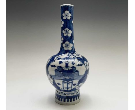 A Chinese porcelain blue and white vase, Kangxi six character mark, each cartouche filled with a vase of flowers on stand, th