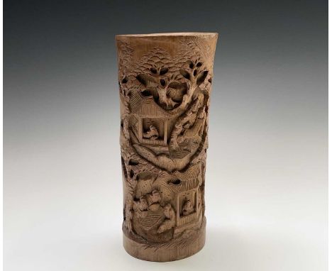 A Chinese bamboo brush pot, 20th century, carved with figures conversing, inspecting a scroll and playing a game, fringed wit