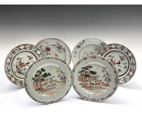 A pair of Chinese famille rose porcelain plates, 18th century, each decorated with deer beneath a tree and pagoda in the back