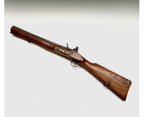 An Indian flintlock blunderbuss, probably 19th century, with figured stock, the lock plate stamped Tower and with a crown, wi