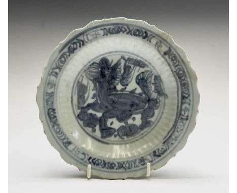 A Chinese blue and white dish, Ming Dynasty, depicting a Qilin to the centre and character marks in the border, scrolls to re
