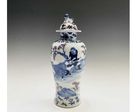 A Chinese porcelain baluster vase and cover, late 19th century, surmounted by a dog of fo, with figures and cattle in a rocky