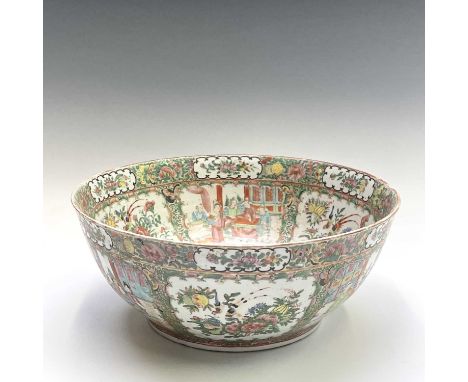 A large Chinese Canton porcelain punch bowl, 19th century, decorated to interior and exterior with panels showing interior sc