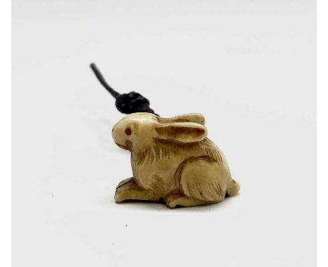 A Japanese ivory netsuke in the form of a hare, circa 1900, height 1.5cm, width 2.2cm.