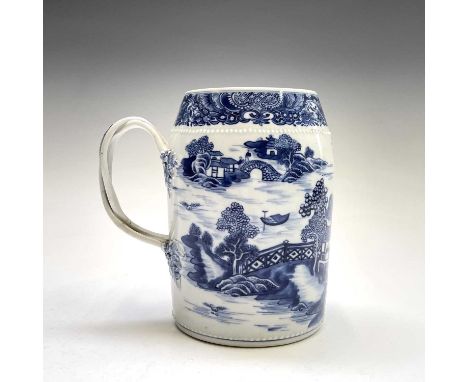 A Chinese Export porcelain blue and white mug, Qianlong Period, with pagodas and trees before a river scene, height 17cm, dia