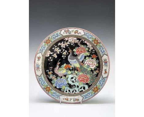 A Chinese famille noire porcelain charger, circa 1900, with exotic birds amongst foliage, with red character mark and impress