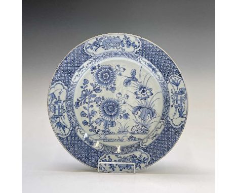 A Chinese Export porcelain blue and white charger, 18th century, with chrysanthemum and further foliage, within a trellis and