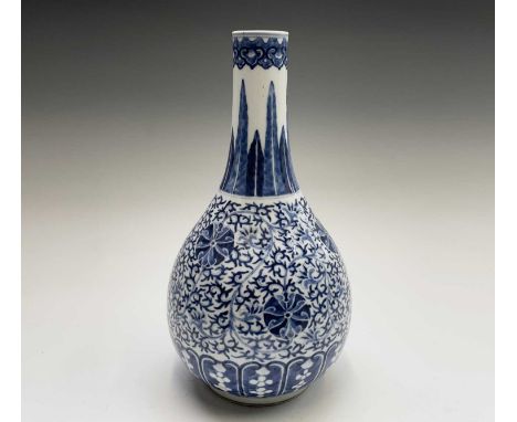 A Chinese Ming style porcelain blue and white bottle vase, late 19th century, with four character Kangxi mark, decorated with