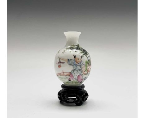 A Chinese famille rose porcelain vase, Republic, 20th century, red seal mark, decorated with three figures in a garden with b