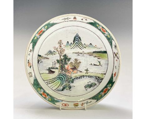 A Chinese famille verte porcelain dish, painted with a coastal scene and distant mountains, diameter 27cm.Provenance:Michael 