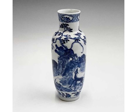 A Chinese porcelain blue and white vase, late 19th century, with a stylised dragon, tiger and other animals beneath a tree in