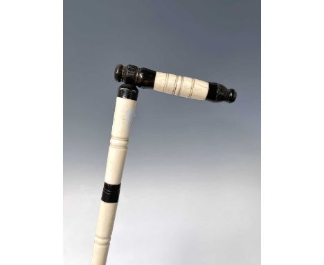 An Anglo Indian ivory and horn walking stick, 19th century, height 84cm, handle full length 15cm.