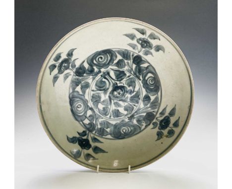 A Chinese blue and white pottery bowl. Ming Dynasty, the centre with flowerheads and foliage, within a stylised plant border,