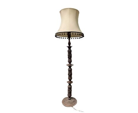 A Chinese hardwood standard lamp, circa 1900, carved with stylised dragons, height 161cm, diameter of base 35cm, total height