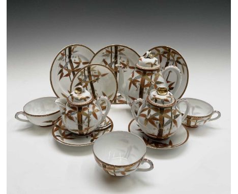 A Japanese porcelain tea service, comprising a coffee pot, teapot, sugar bowl and three cup, saucers and plates, each with re