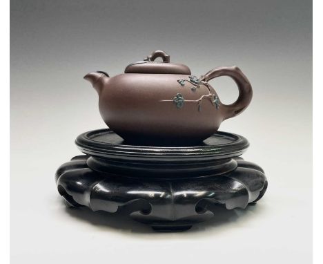 A Chinese yixing teapot, seal mark to base and signed on handle, height 8.5cm, width 16cm and an ebonised vase stand, inner d