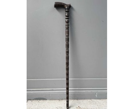 A Persian wooden sectional walking stick, 19th century, with horn handle, the shaft inlaid with copper and white metal, lengt