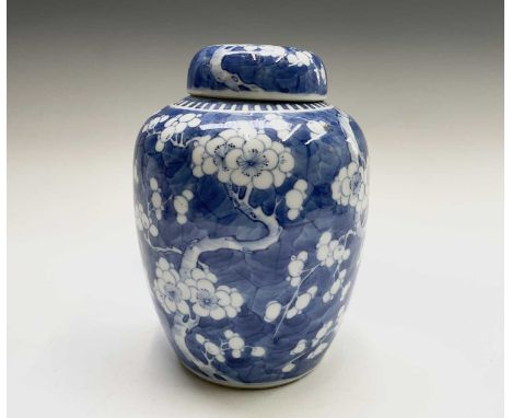 A Chinese porcelain prunus blossom blue and white ginger jar and cover, 19th century, with Kangxi four character mark, height